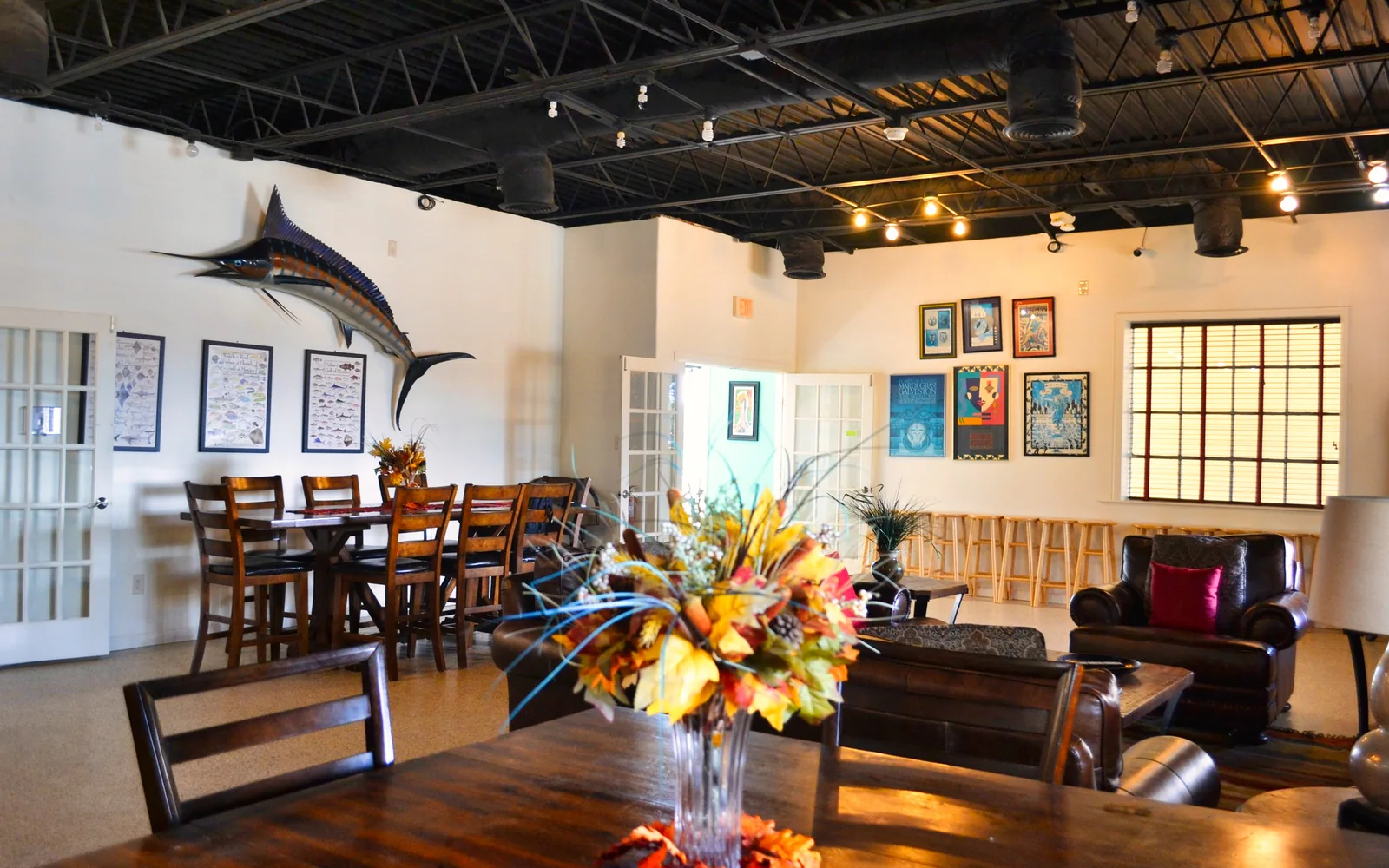 Tables, comfortable seating, and coastal artwork in the resort's social room