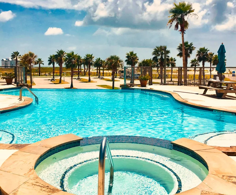 The infinity pool and hot tub, with palms and the Gulf beyond
