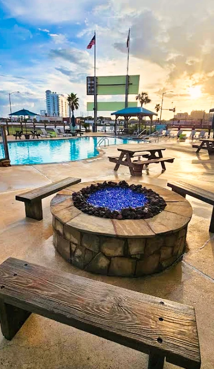 The stone fire pit beside the resort pool in warm sunset light