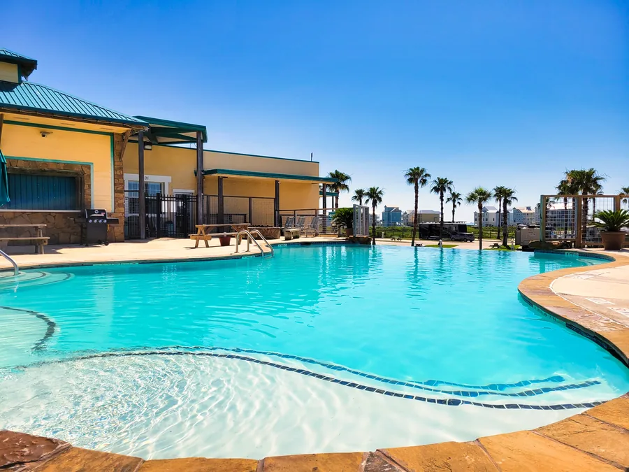 The Sandpiper pool with the pool house and palms behind it