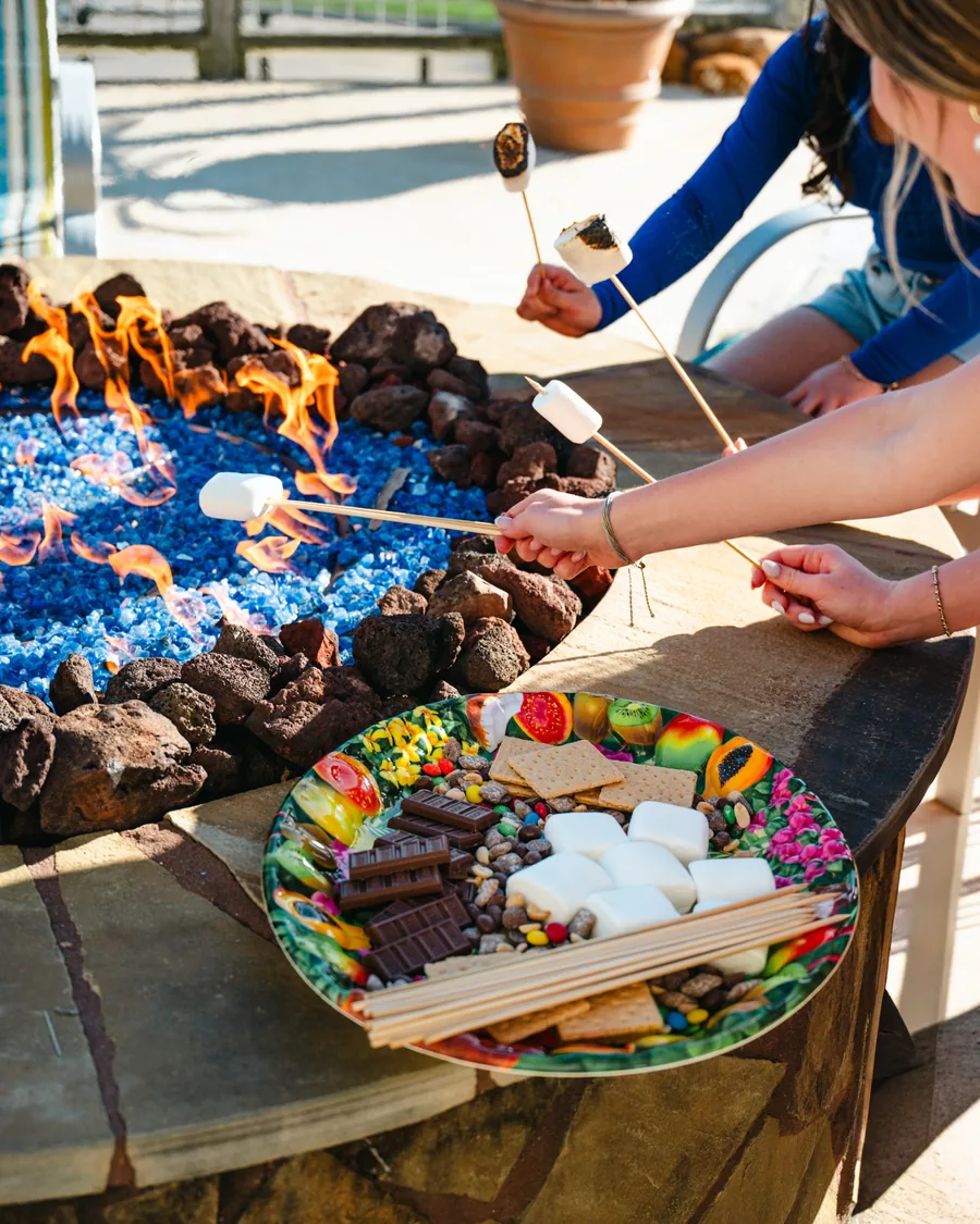 Guests making s’mores around the fire pit